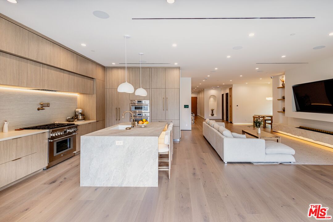 4703 Saloma Avenue Sherman Oaks, CA 91403 - Photo 6 of 26 a living room with stainless steel appliances furniture a flat screen tv and a kitchen view