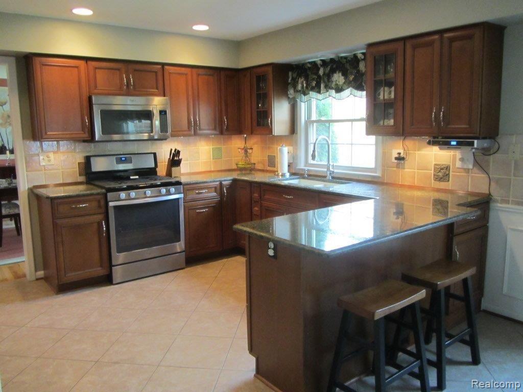 588 Rivard Boulevard Grosse Pointe, MI 48230 - Photo 5 of 6 #12 Cherry cabinets, granite counters.jpg