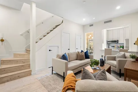 a living room with furniture and white walls