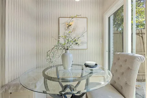 a dining room with furniture and window