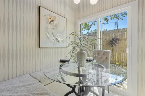 a dining room with furniture and wooden floor