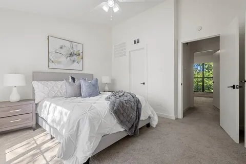 a bedroom with a bed and a chandelier