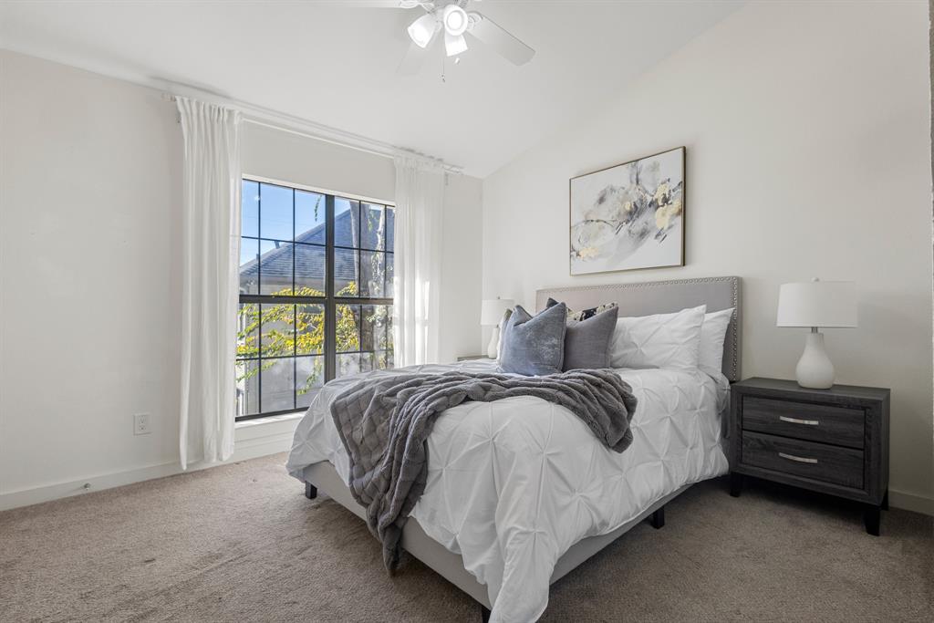 2806 Knight Street, Unit 103 Dallas, TX 75219 - Photo 10 of 17 a spacious bedroom with a bed a couch and a window