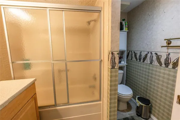 a bathroom with a toilet and a shower