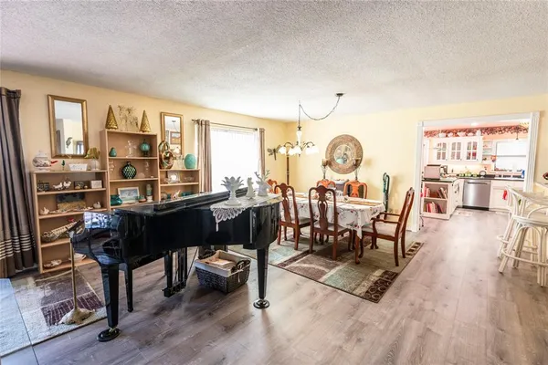 a living room with furniture a fireplace and a large window