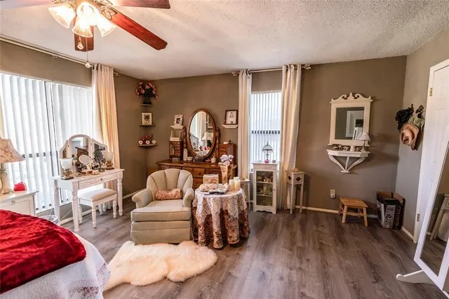 a bedroom with furniture and a wooden floor