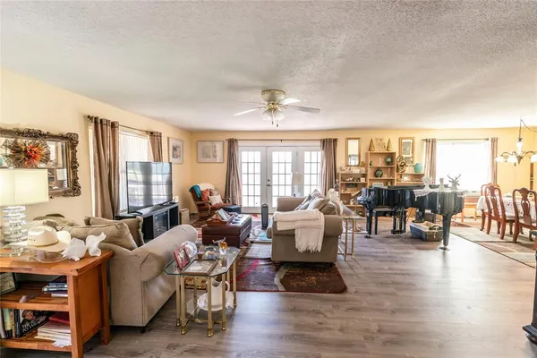 a living room with furniture and wooden floor