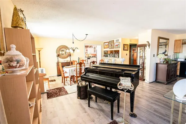 a living room with furniture a wooden floor and next to a window
