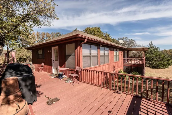 a view of a house with a wooden deck