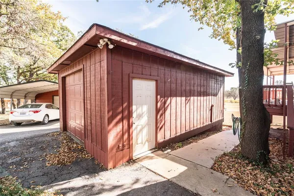 a view of a house with a small yard and wooden fence