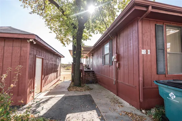 a view of a house with a large tree