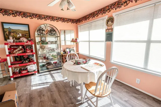 a view of a dining room with furniture a chandelier and wooden floor
