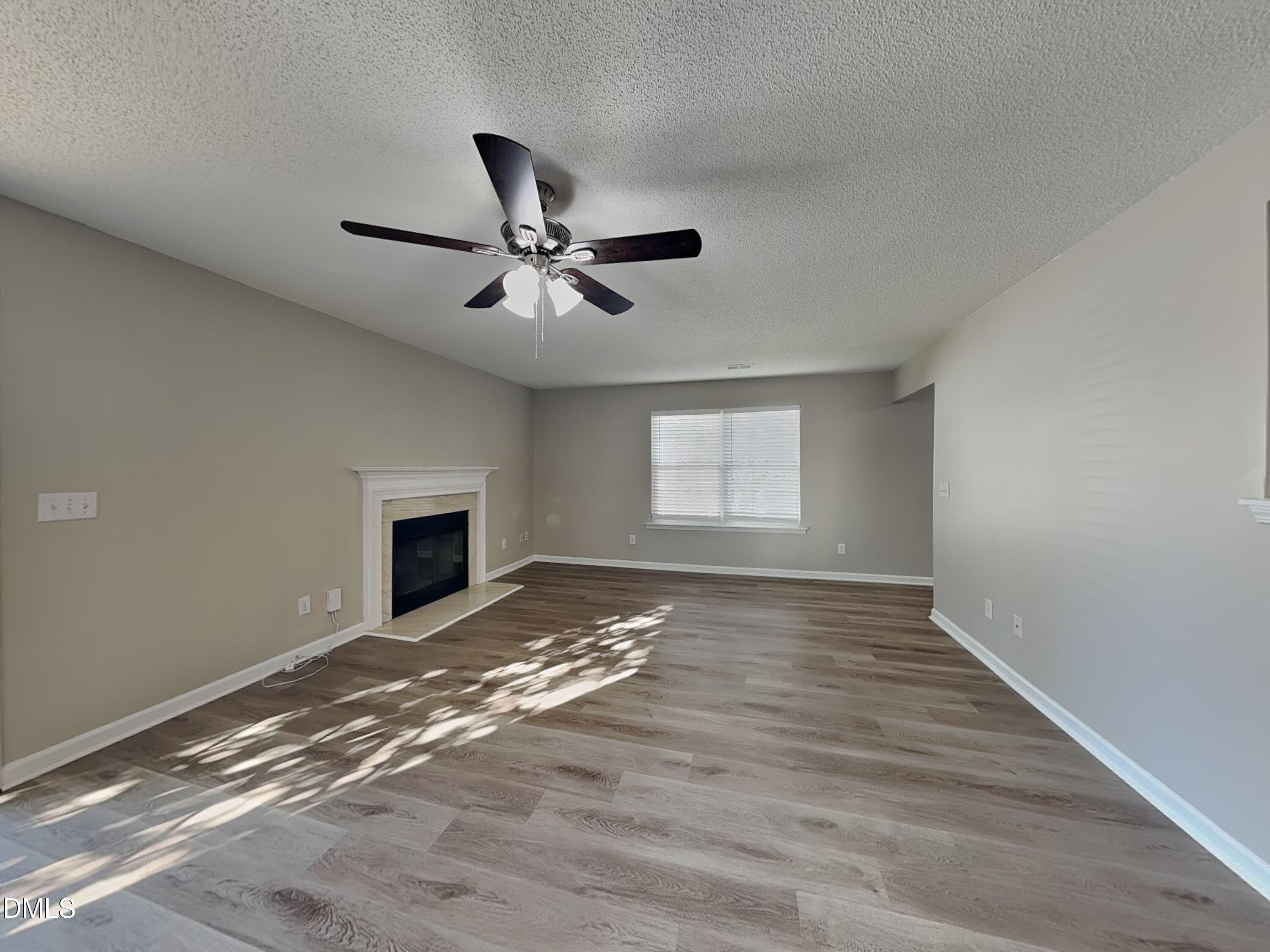 8109 Bright Oak Trail Raleigh, NC 27616 - Photo 2 of 15 a view of an empty room with window and fire place