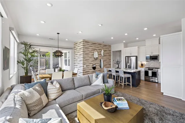 a living room with furniture kitchen and a table