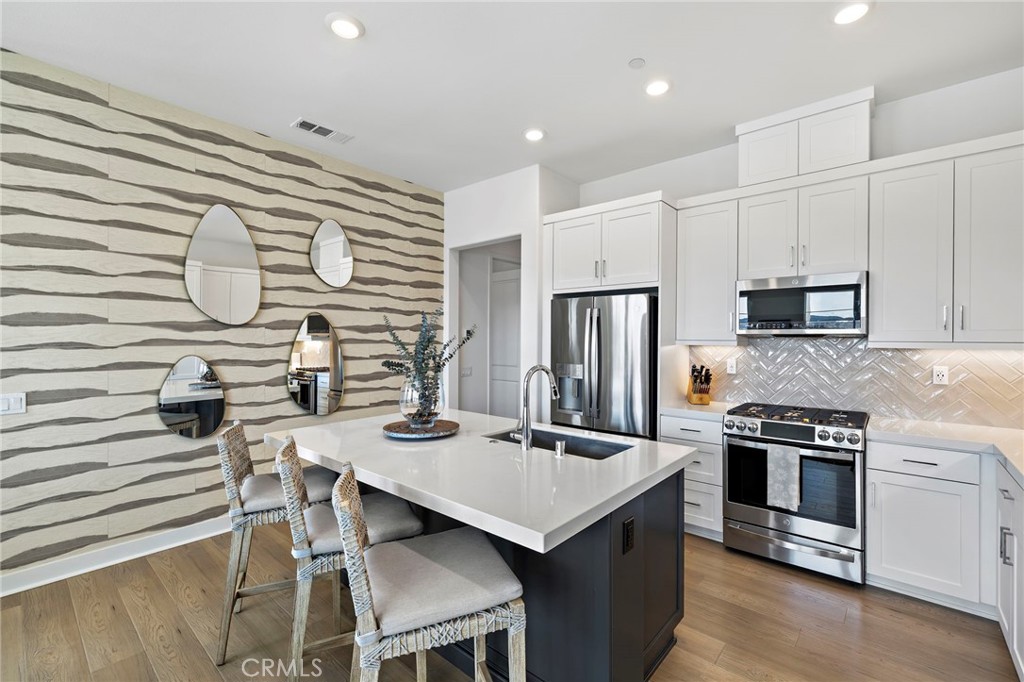 896 Sunrise Road Rancho Mission Viejo, CA 92694 - Photo 12 of 42 a kitchen that has a cabinets and a stove