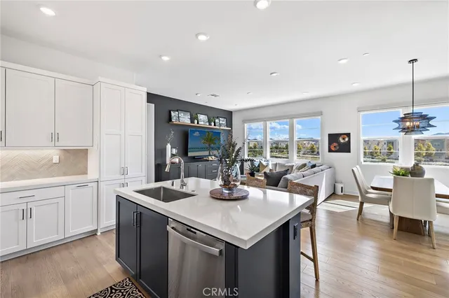 a kitchen with a table chairs and wooden floor