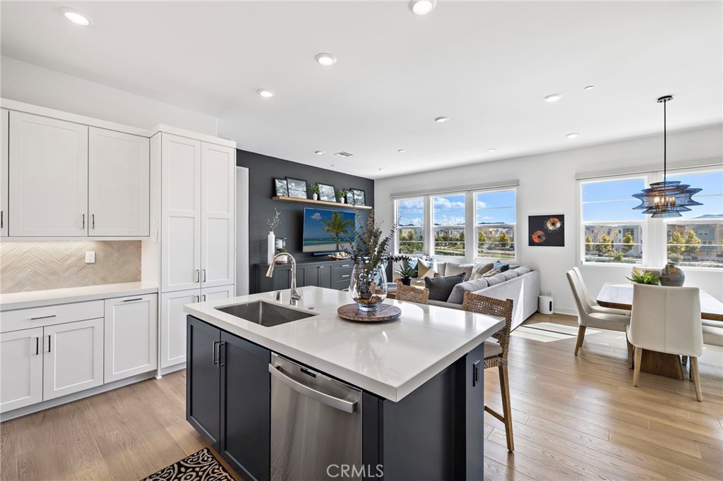 896 Sunrise Road Rancho Mission Viejo, CA 92694 - Photo 15 of 42 a kitchen with a table chairs and wooden floor