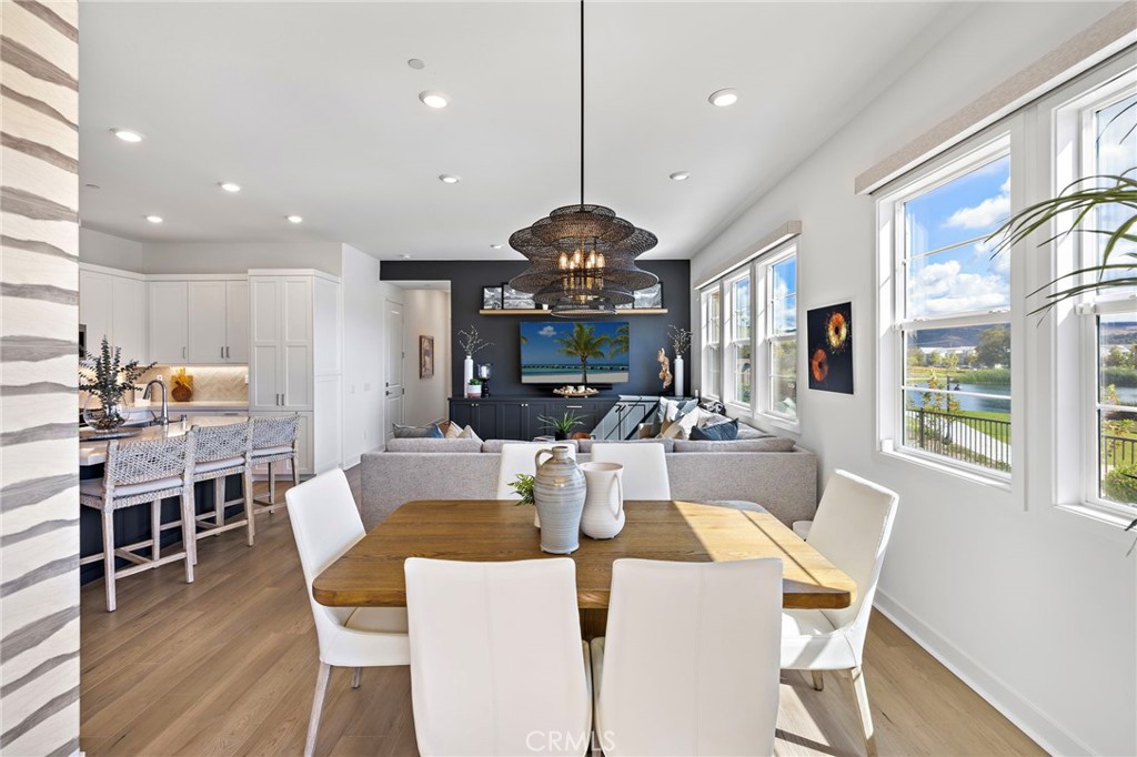 896 Sunrise Road Rancho Mission Viejo, CA 92694 - Photo 19 of 42 a view of a dining room with furniture window and wooden floor