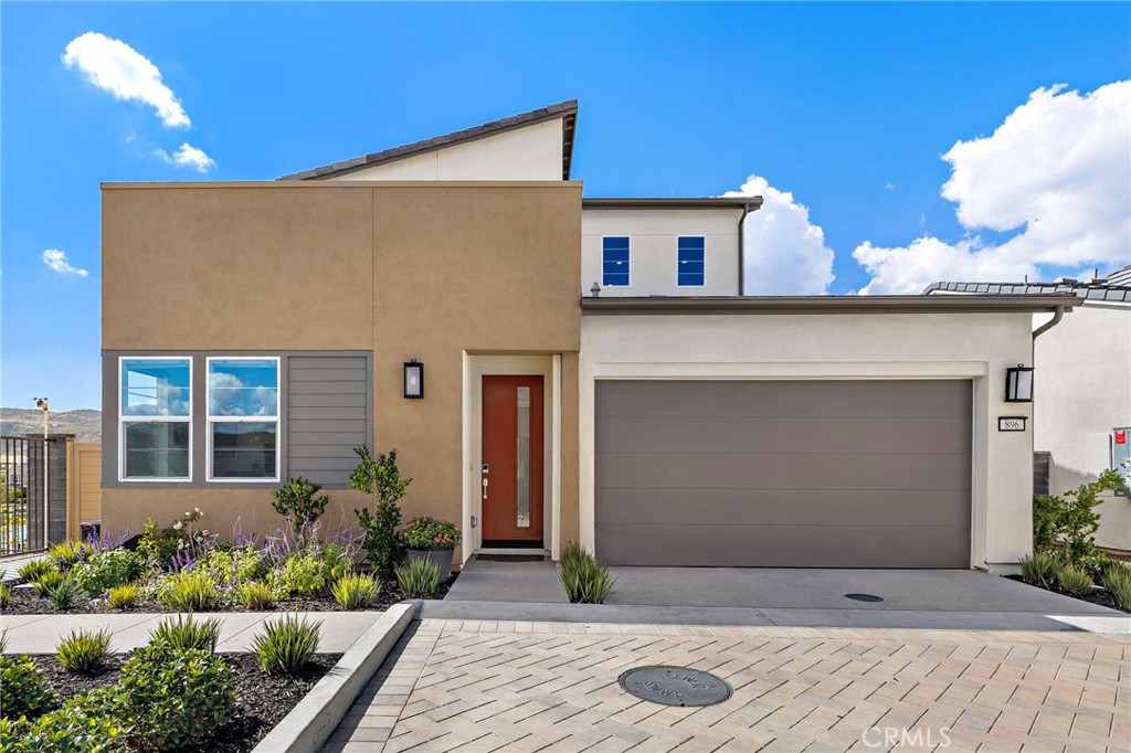 896 Sunrise Road Rancho Mission Viejo, CA 92694 - Photo 2 of 42 a front view of a house with plants