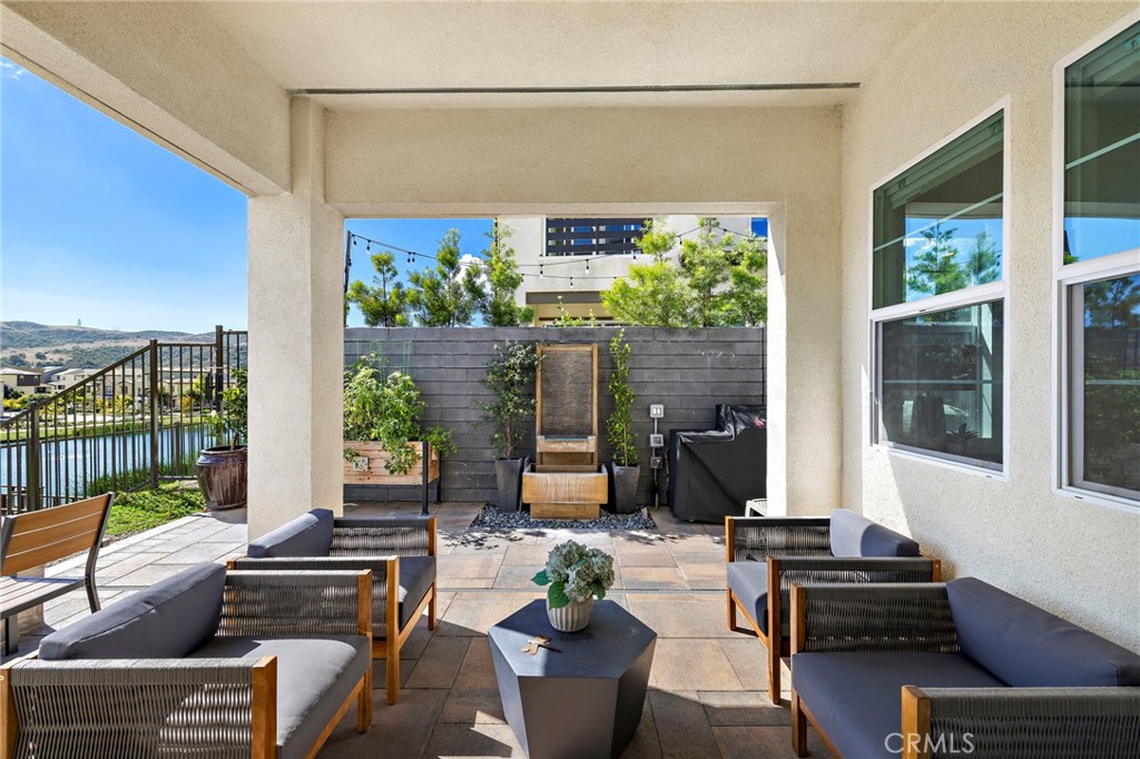 896 Sunrise Road Rancho Mission Viejo, CA 92694 - Photo 21 of 42 a living room with furniture and a floor to ceiling window