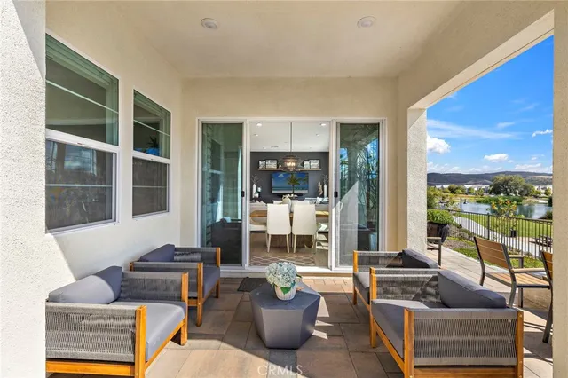 a living room with furniture a lamp and a large window