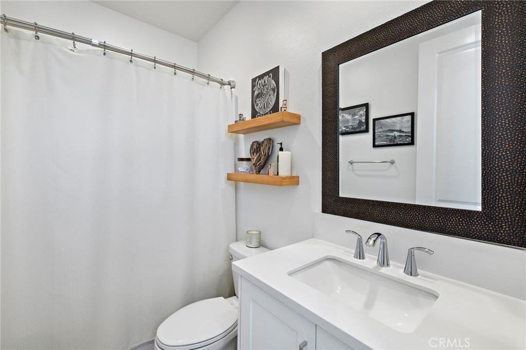 896 Sunrise Road Rancho Mission Viejo, CA 92694 - Photo 32 of 42 a bathroom with a toilet sink and mirror