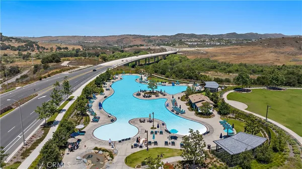 an aerial view of a swimming pool and mountain view in back