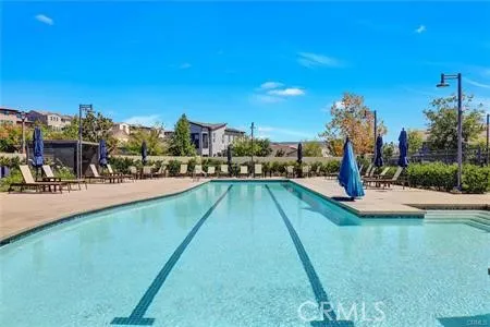 a view of swimming pool with a yard and a fountain