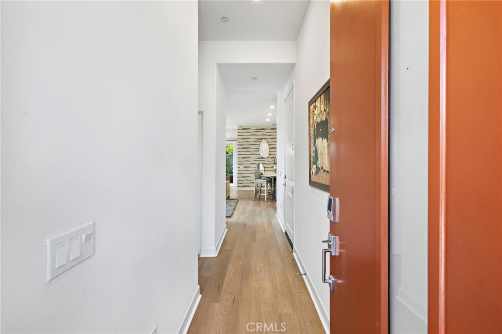 896 Sunrise Road Rancho Mission Viejo, CA 92694 - Photo 6 of 42 a view of a hallway with wooden floor and staircase