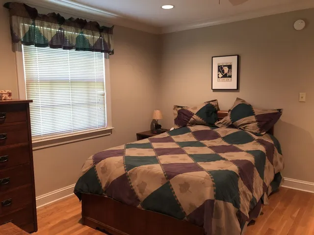 a bed sitting in a bedroom next to a window