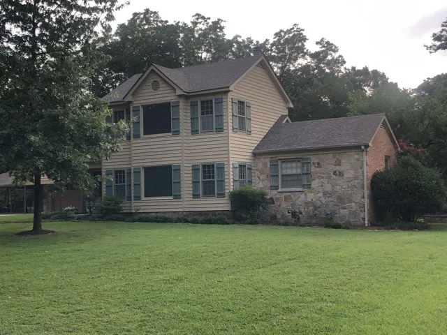 a front view of a house with a garden