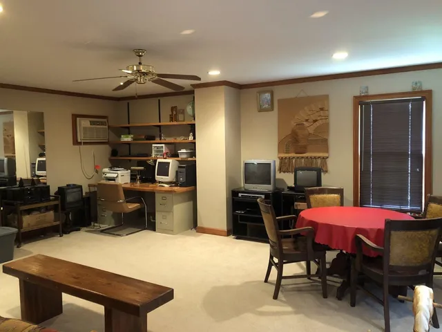 a kitchen with a table chairs refrigerator and cabinets