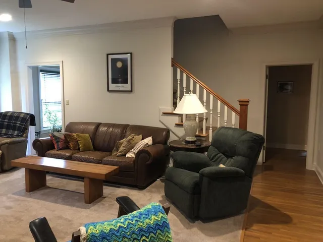 a living room with furniture and a lamp