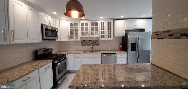 a kitchen with a sink stove and refrigerator