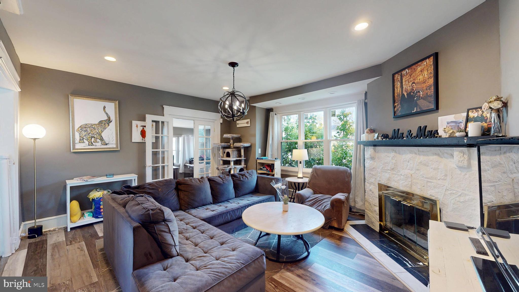 204 Haddon Avenue Collingswood, NJ 08108 - Photo 9 of 34 a living room with furniture a fireplace and a flat screen tv