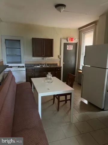a view of kitchen with stainless steel appliances granite countertop a sink and a refrigerator