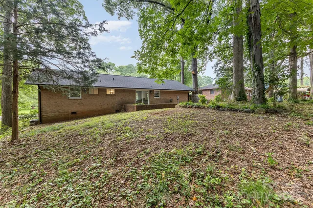 front view of a house with a large tree