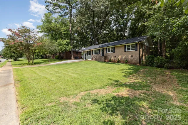 a view of a house with a yard and a garage