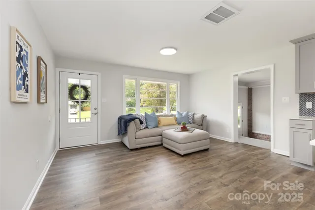 a living room with furniture and a large window