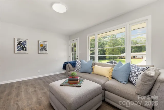 a living room with furniture and a large window