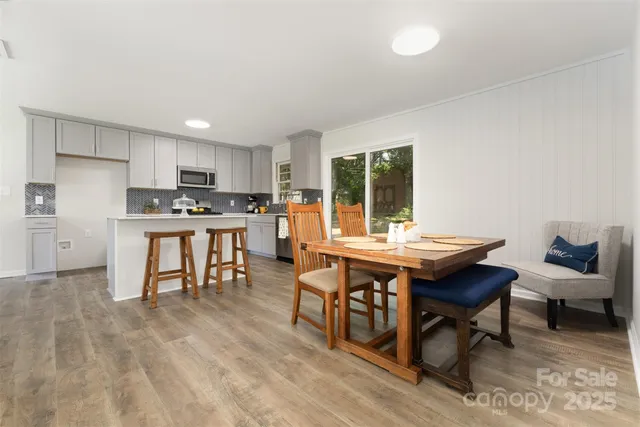 a view of a kitchen with a table and chairs in it