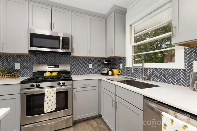 a kitchen with a sink stove and microwave