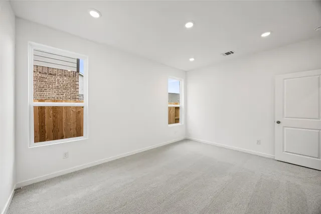 a bathroom with a granite countertop sink a toilet and a shower