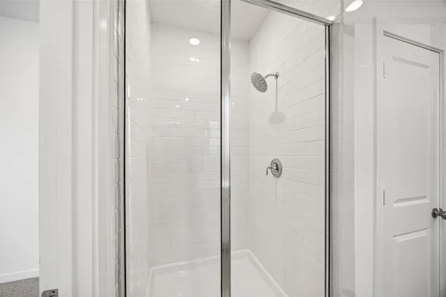 a bathroom with a double vanity sink and mirror with shower