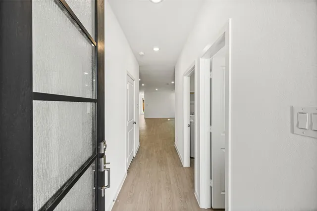 a view of hallway with wooden floor