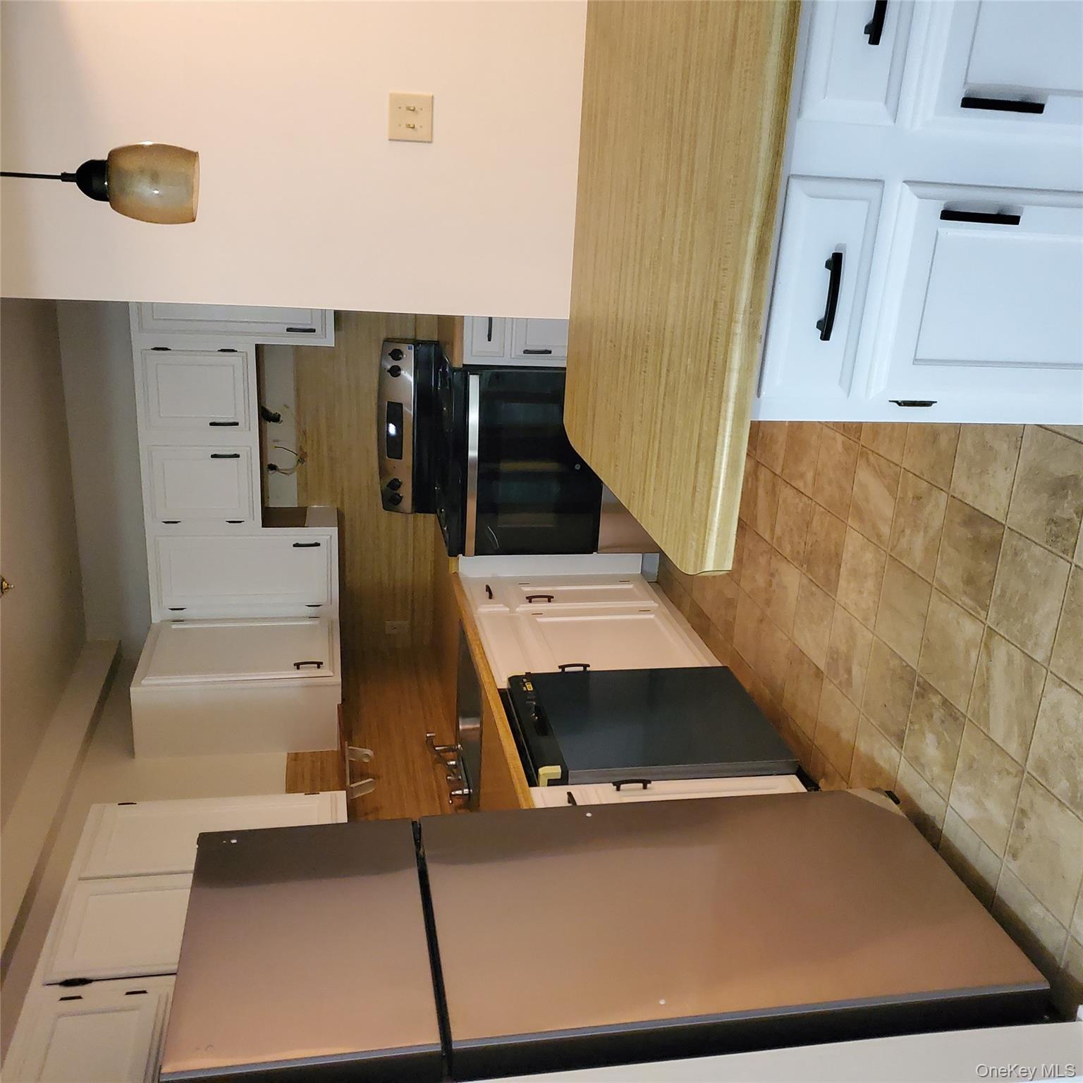 160-166 W Road, Unit C34 Pleasant Valley, NY 12569 - Photo 4 of 8 a kitchen with stainless steel appliances granite countertop a refrigerator sink and stove