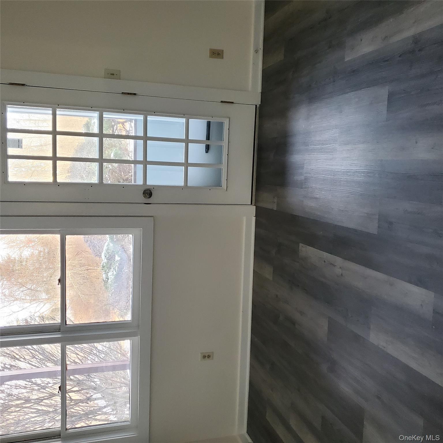 160-166 W Road, Unit C34 Pleasant Valley, NY 12569 - Photo 6 of 8 an empty room with wooden floor and windows