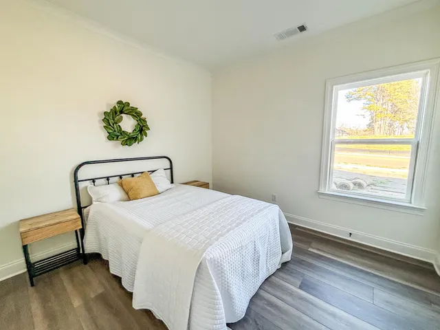 a bedroom with a bed and a window