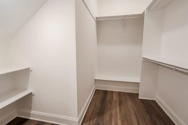 an empty room with a ceiling fan and window