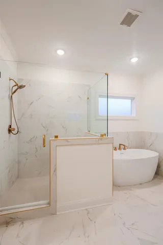 a bathroom with a tub sink and mirror
